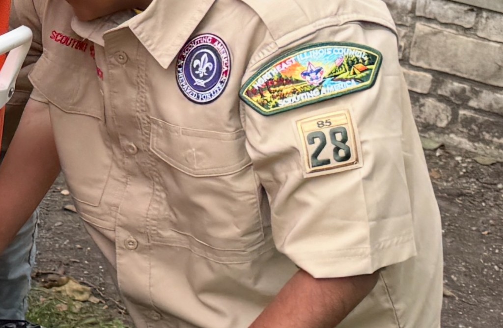 Tan 5th-grade shirt with the Scouting America emblem, Northeast Illinois Council patch, and numerals 28